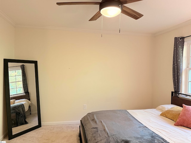 bedroom featuring light colored carpet, ceiling fan, and crown molding