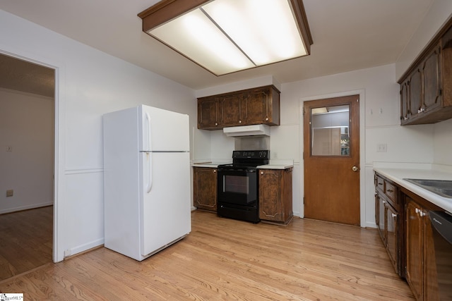 kitchen featuring dark brown cabinets, sink, light hardwood / wood-style floors, and black appliances