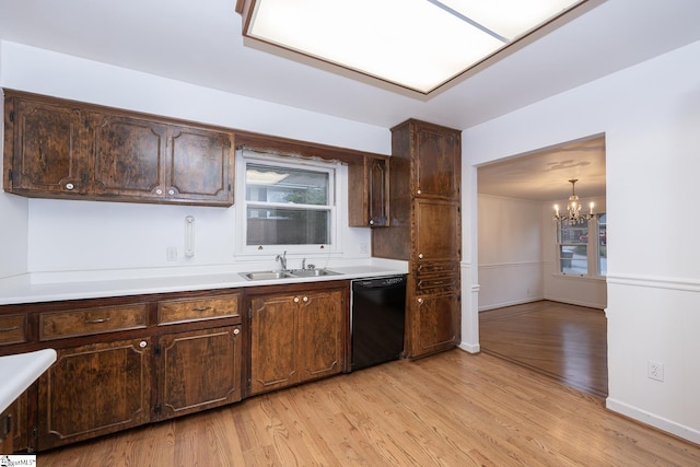 kitchen with dark brown cabinets, black dishwasher, sink, and light wood-type flooring