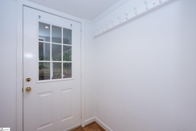 doorway to outside with crown molding