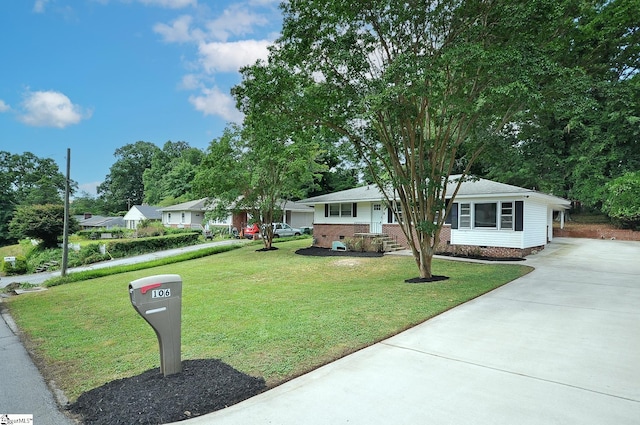 single story home with a carport and a front yard