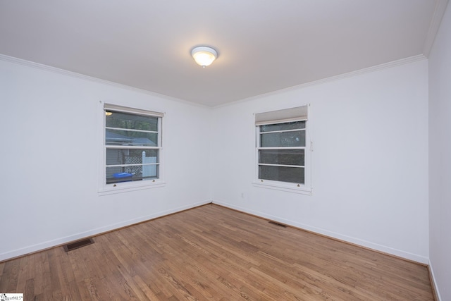 unfurnished room featuring crown molding and hardwood / wood-style floors