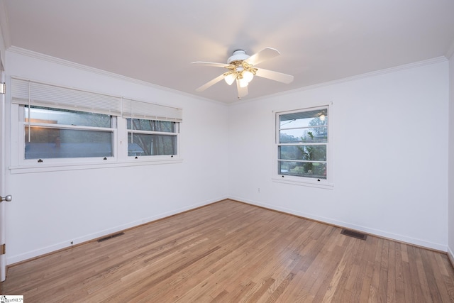 unfurnished room featuring light hardwood / wood-style flooring, ornamental molding, and ceiling fan