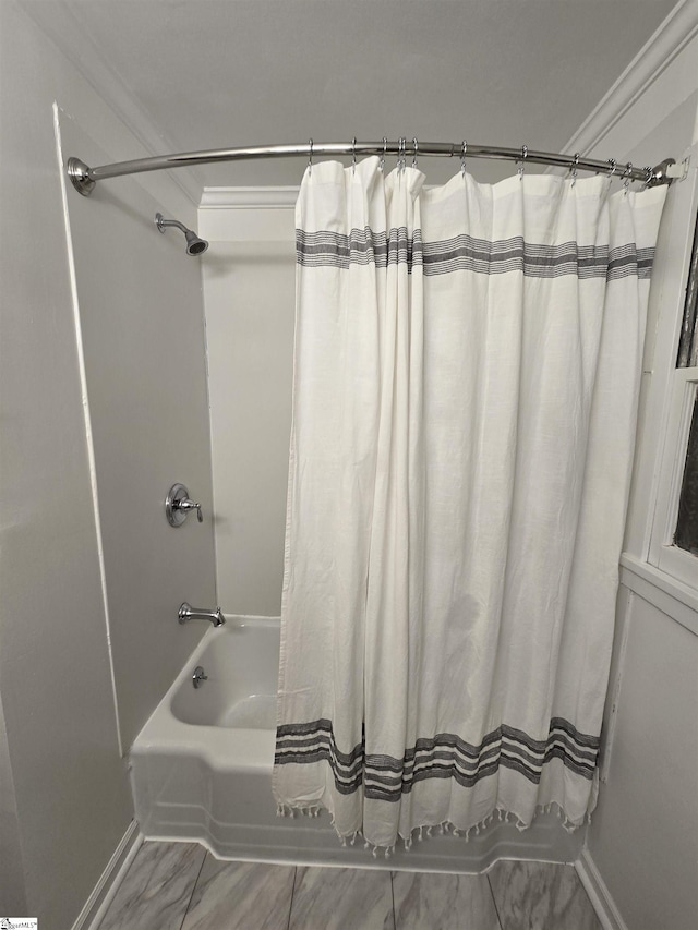 bathroom featuring shower / bathtub combination with curtain and ornamental molding