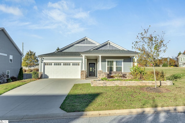 craftsman inspired home featuring a front lawn and a garage