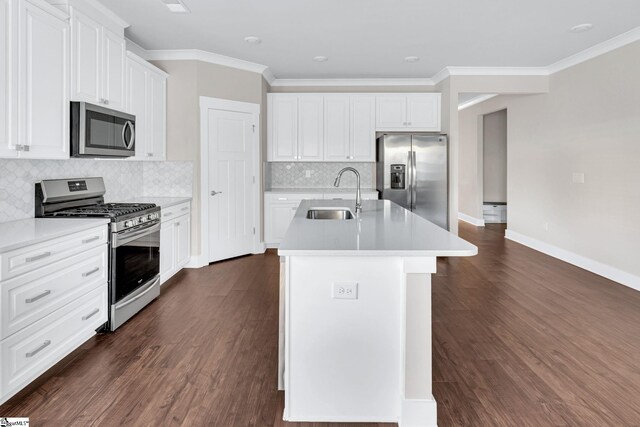 kitchen featuring appliances with stainless steel finishes, a kitchen island with sink, sink, dark hardwood / wood-style floors, and white cabinetry