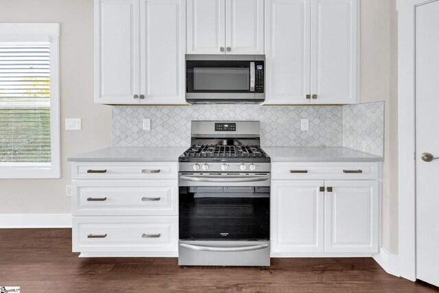 kitchen featuring white cabinets, appliances with stainless steel finishes, and dark wood-type flooring