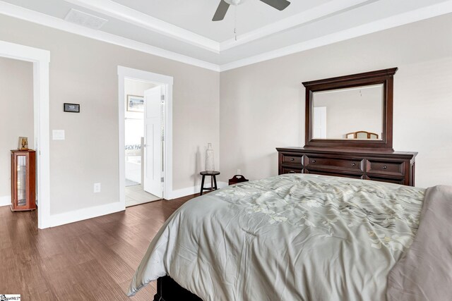 bedroom with ensuite bathroom, hardwood / wood-style flooring, and ceiling fan