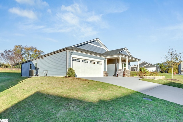 view of front of house featuring cooling unit, a garage, and a front lawn