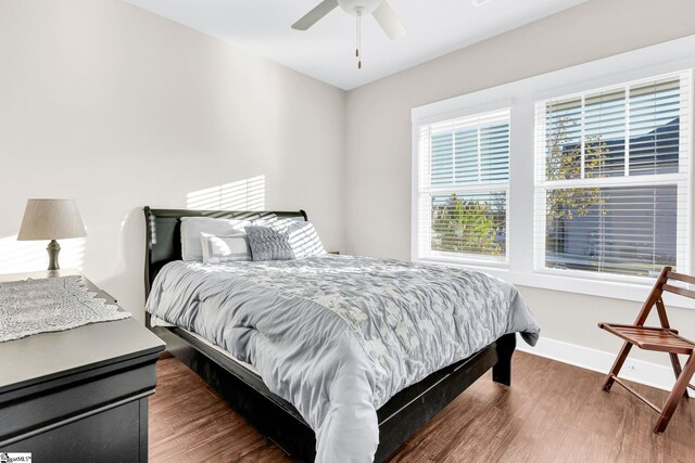 bedroom featuring ceiling fan and dark wood-type flooring