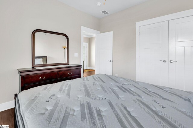 bedroom with hardwood / wood-style flooring and a closet