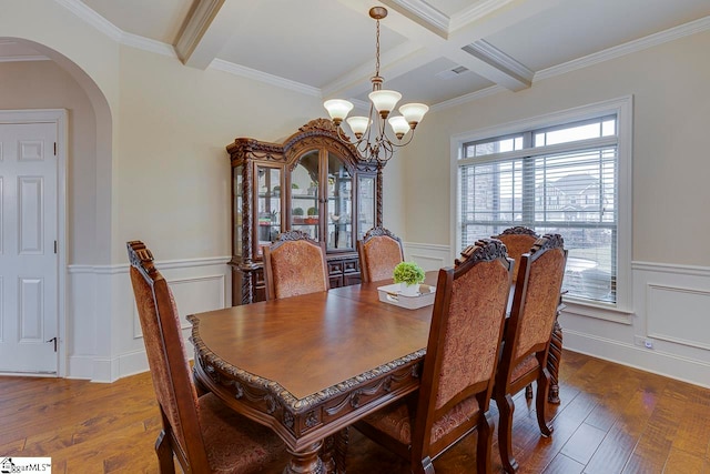 dining room featuring beamed ceiling, plenty of natural light, and crown molding