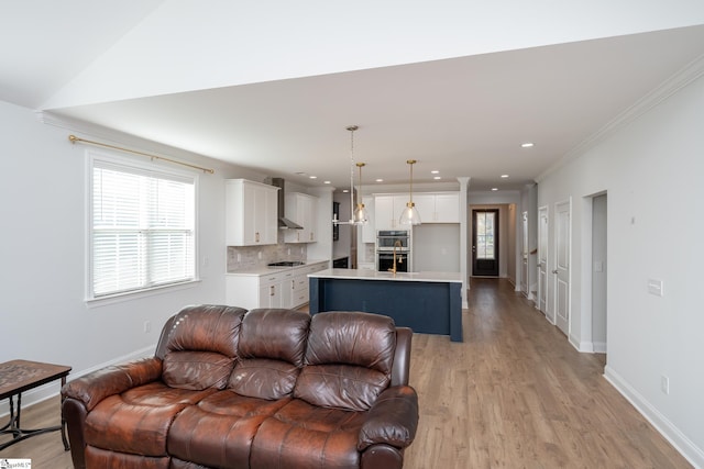 living room featuring light wood-type flooring and crown molding