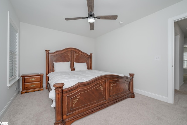 bedroom with ceiling fan and light carpet