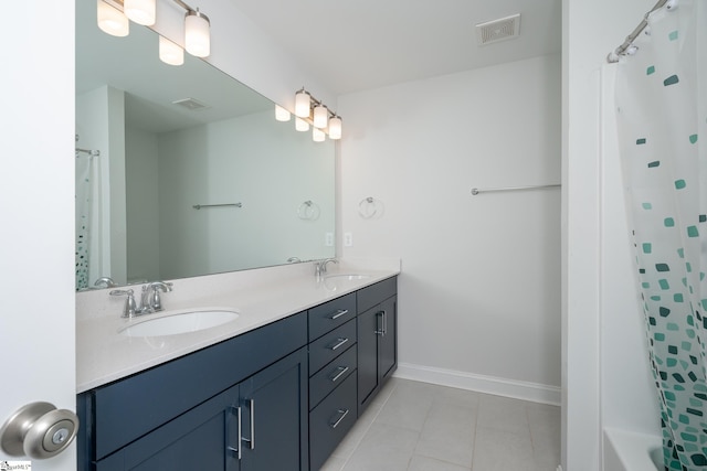 bathroom featuring tile patterned floors, vanity, and shower / bath combo