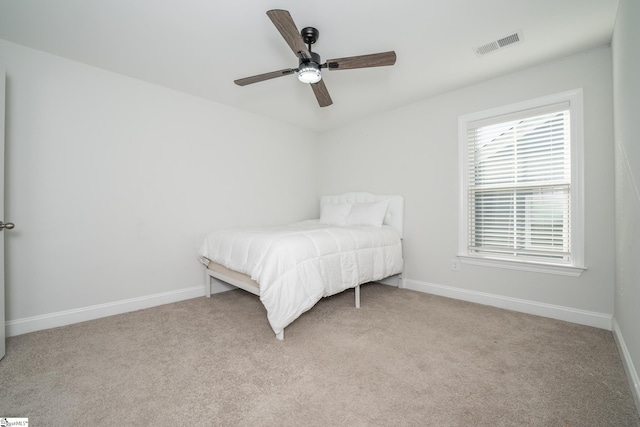 unfurnished bedroom with ceiling fan and light colored carpet