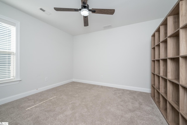 empty room with light colored carpet and ceiling fan