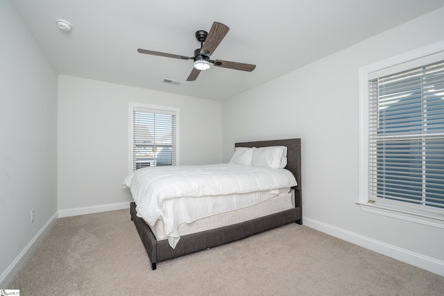 bedroom with light colored carpet and ceiling fan