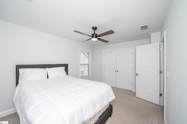 carpeted bedroom with a closet and ceiling fan