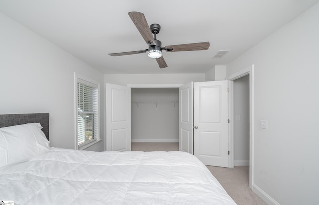 carpeted bedroom with ceiling fan and a closet