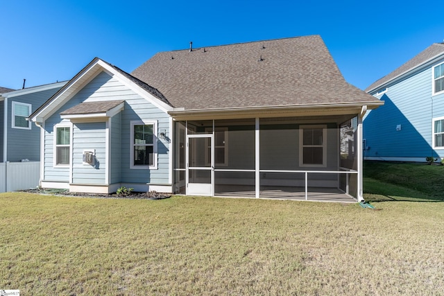 back of house with a sunroom and a lawn