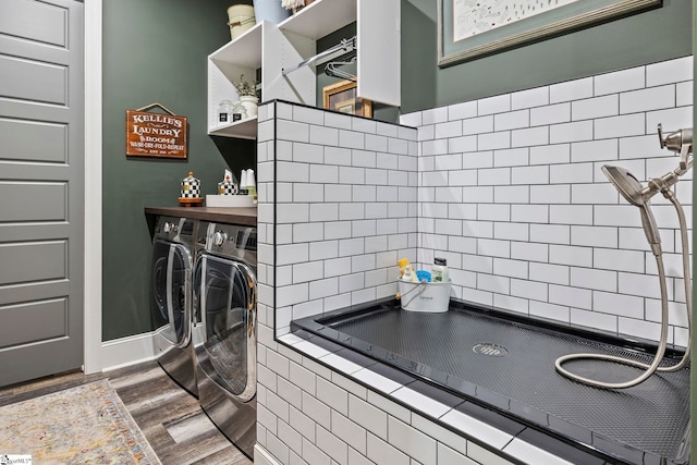 laundry area with hardwood / wood-style floors and washer and clothes dryer