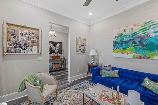 living room featuring ceiling fan, ornamental molding, and dark wood-type flooring