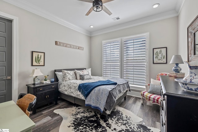 bedroom featuring dark hardwood / wood-style flooring, ceiling fan, and ornamental molding