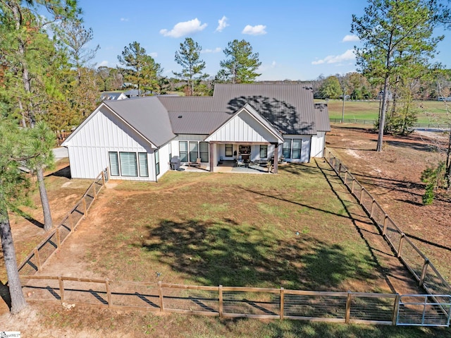 back of property featuring a patio area and a yard