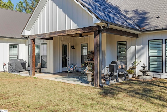 back of property with ceiling fan, a yard, and a patio