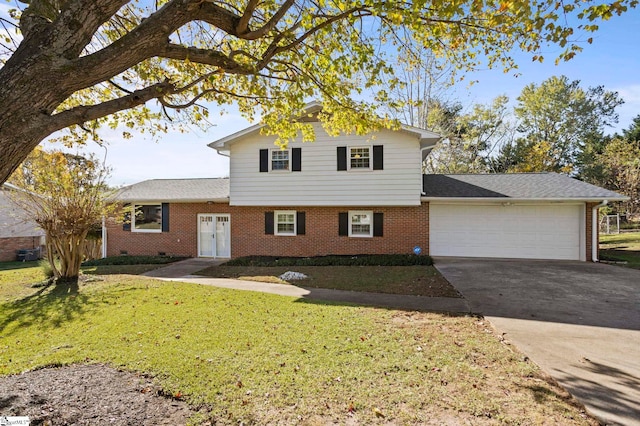 view of front of house with a front lawn and a garage