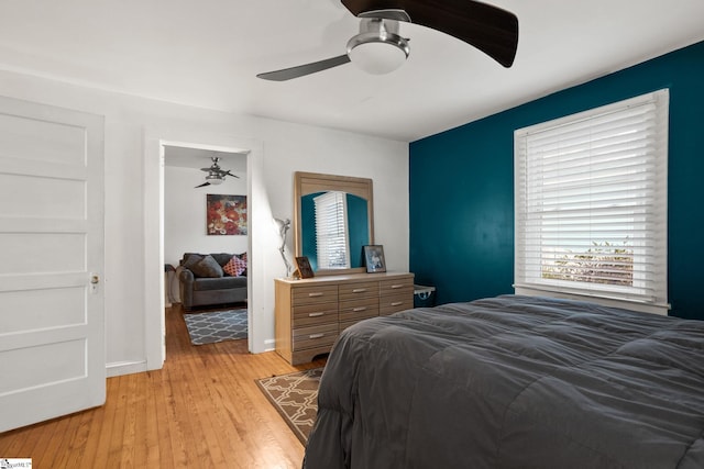 bedroom with ceiling fan and light hardwood / wood-style flooring