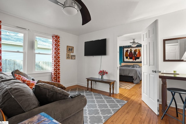 living room featuring ceiling fan and wood-type flooring