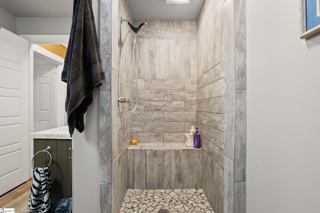 bathroom featuring tiled shower and hardwood / wood-style flooring