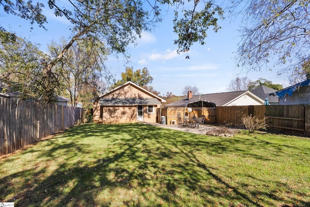 back of house with a patio and a lawn