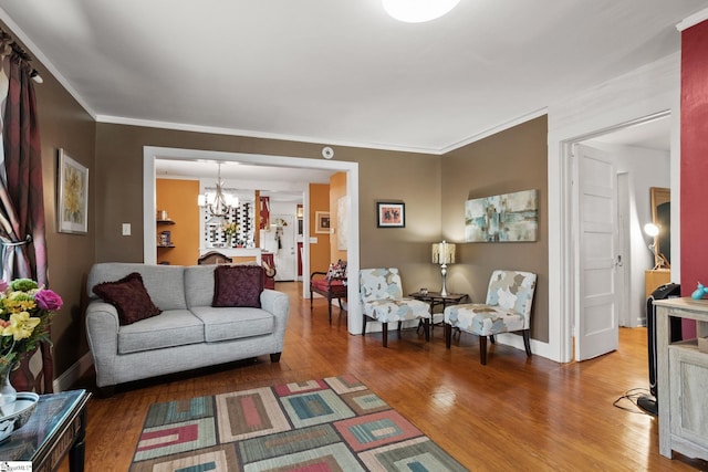 living room with a chandelier, wood-type flooring, and crown molding