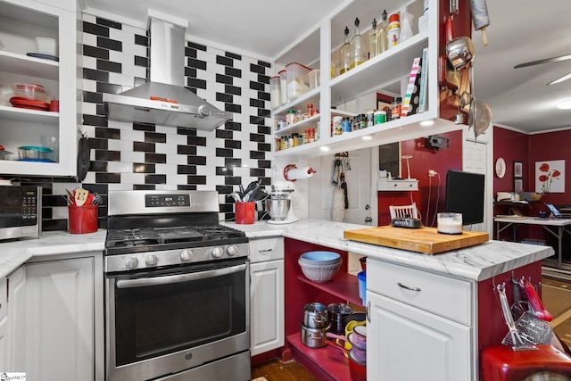 kitchen with stainless steel appliances, white cabinetry, tasteful backsplash, and wall chimney range hood