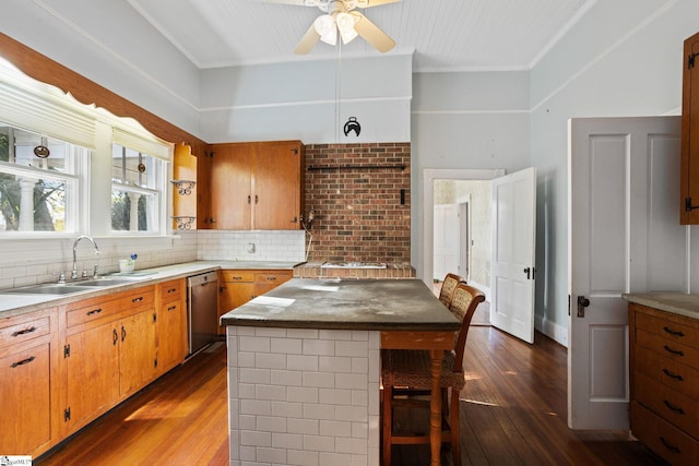 kitchen featuring ceiling fan, crown molding, sink, dishwasher, and dark hardwood / wood-style floors