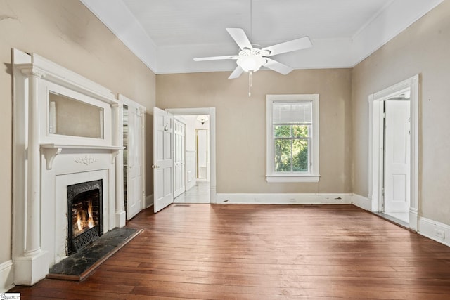 unfurnished living room featuring dark hardwood / wood-style flooring and ceiling fan