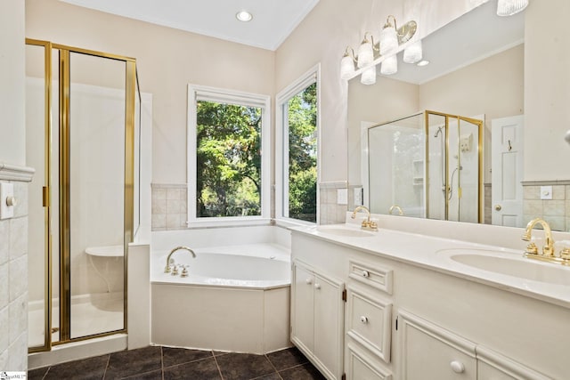 bathroom featuring tile patterned flooring, vanity, crown molding, and shower with separate bathtub