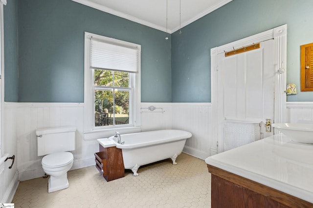 bathroom with tile patterned floors, crown molding, sink, a bath, and toilet