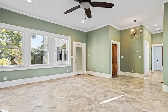 empty room featuring ceiling fan with notable chandelier and crown molding