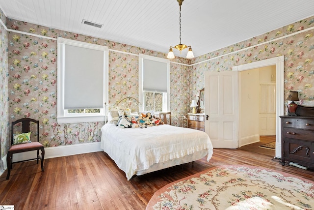 bedroom with wood ceiling and hardwood / wood-style flooring