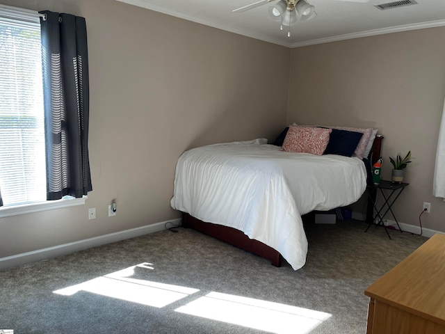 carpeted bedroom featuring ceiling fan and crown molding