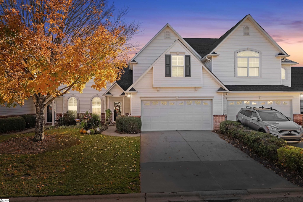 view of front of property featuring a yard and a garage