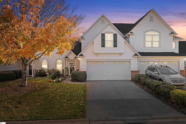 view of front of property featuring a yard and a garage