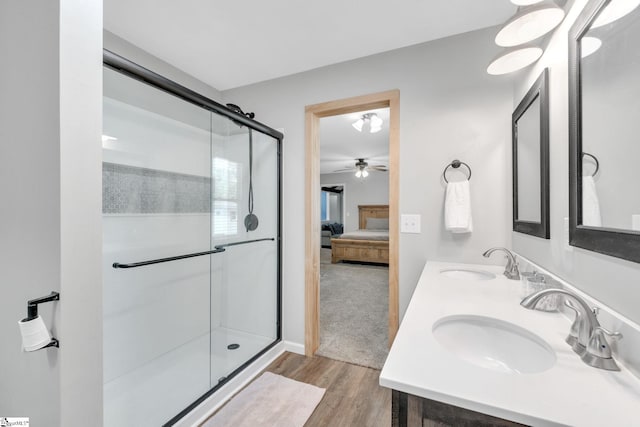 bathroom featuring vanity, hardwood / wood-style flooring, ceiling fan, and a shower with shower door