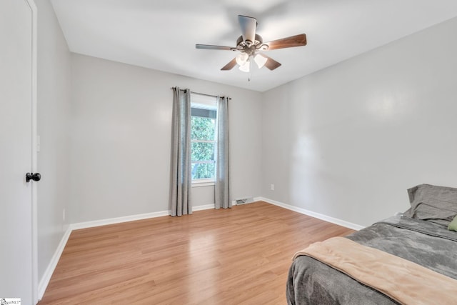 bedroom with ceiling fan and light hardwood / wood-style floors