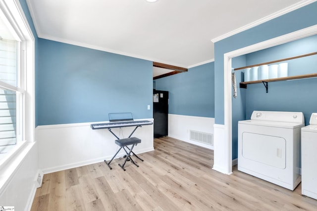 laundry room with washer and dryer, light hardwood / wood-style floors, and ornamental molding