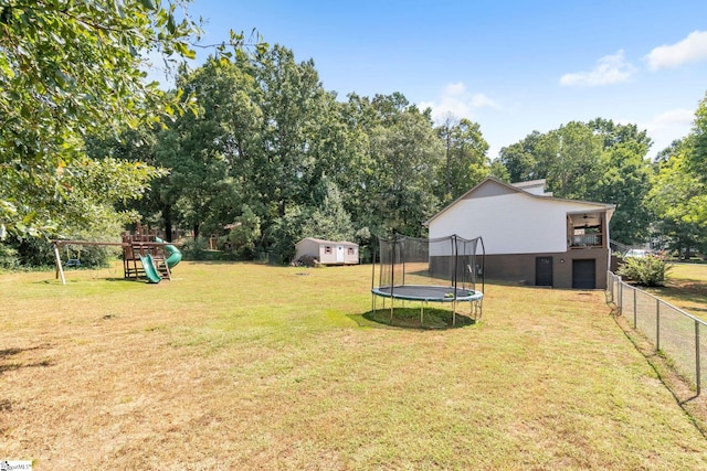 view of yard with a playground and a trampoline